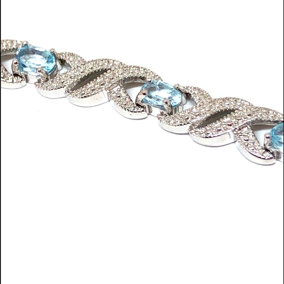 Rhodium Plated Blue Topaz Infinity Bracelet - Picture 1 of 11